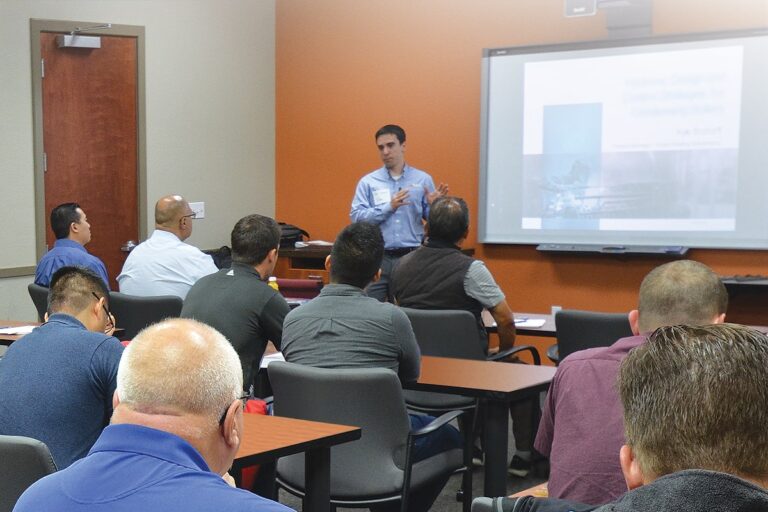 A member of Fulton's management team teaching a classroom full of staff about boiler components
