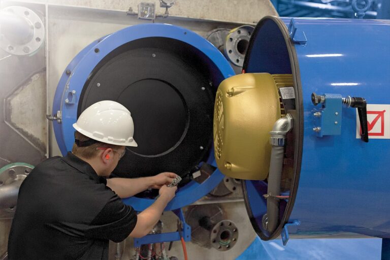A Fulton certified team member checking over a boiler component